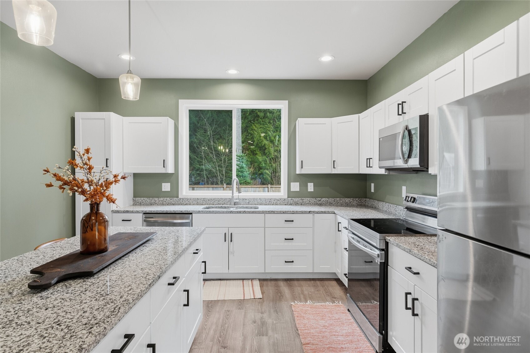 8470 Golden Valley Drive Maple Falls, WA 98266 - Photo 7 of 30 a kitchen with granite countertop a sink stainless steel appliances and cabinets