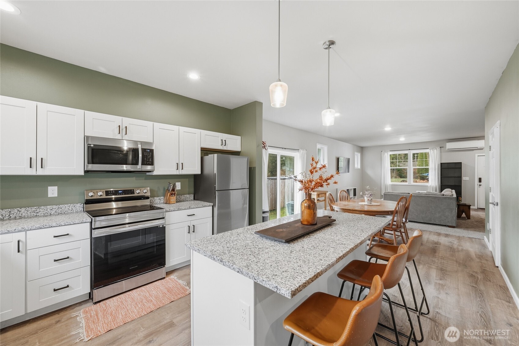 8470 Golden Valley Drive Maple Falls, WA 98266 - Photo 8 of 30 a kitchen with stainless steel appliances granite countertop a stove refrigerator a microwave oven a sink with island and chairs