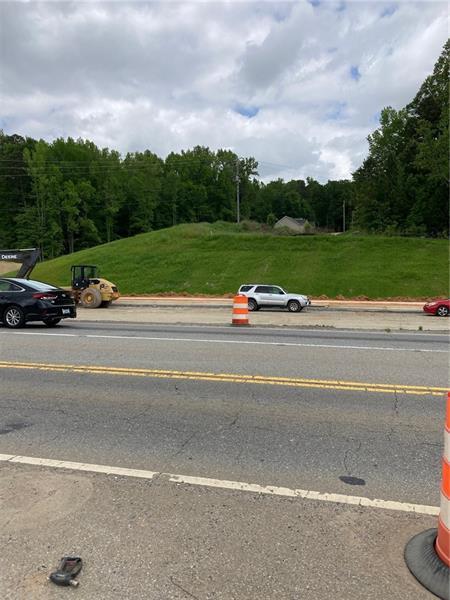 a view of a street with a car parked on the road