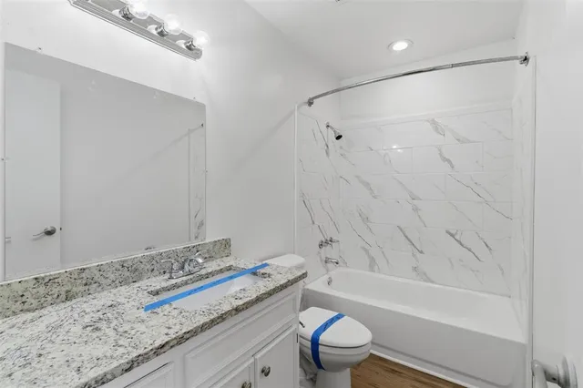 a bathroom with a bathtub and a toilet