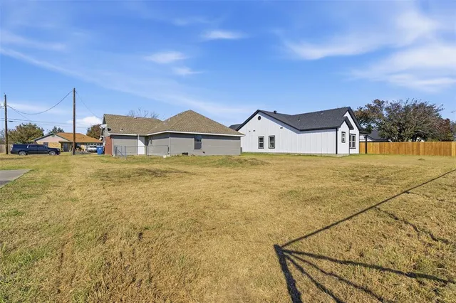 a view of a big yard with an ocean view