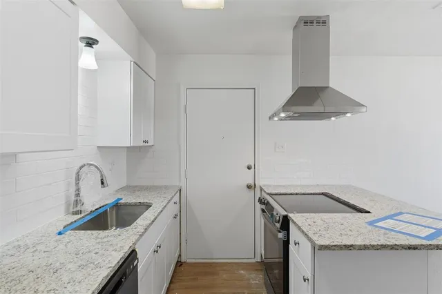 a kitchen with a sink stove and cabinets