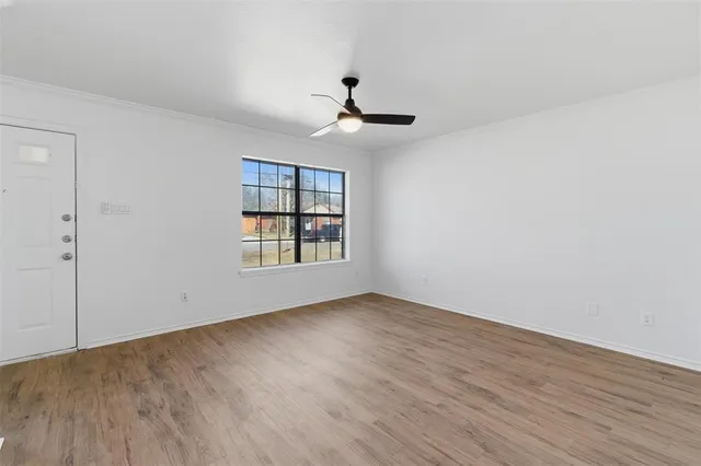 wooden floor in an empty room with a window