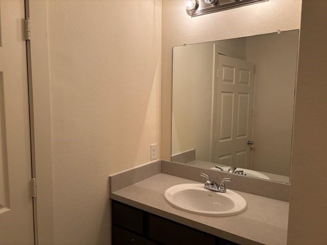 4744 Stokes Street Dallas, TX 75216 - Photo 11 of 20 a bathroom with a sink and a mirror