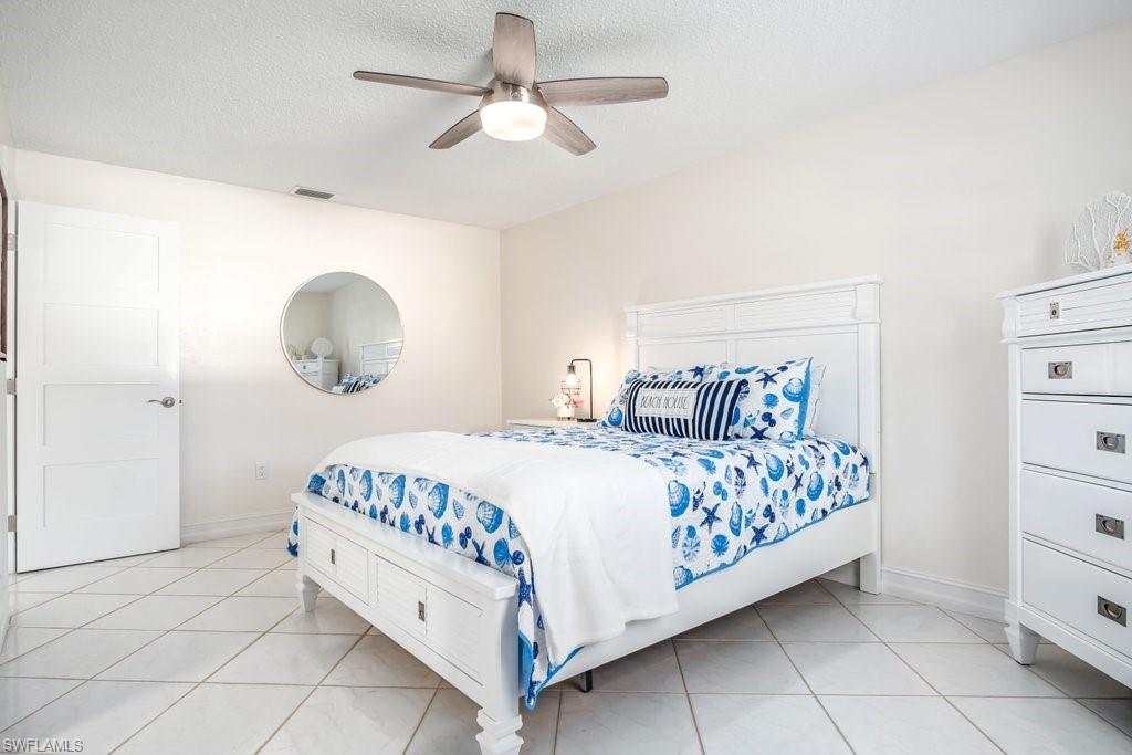 1207 Hernando Street Naples, FL 34103 - Photo 18 of 37 a bed room with a bed and a chandelier