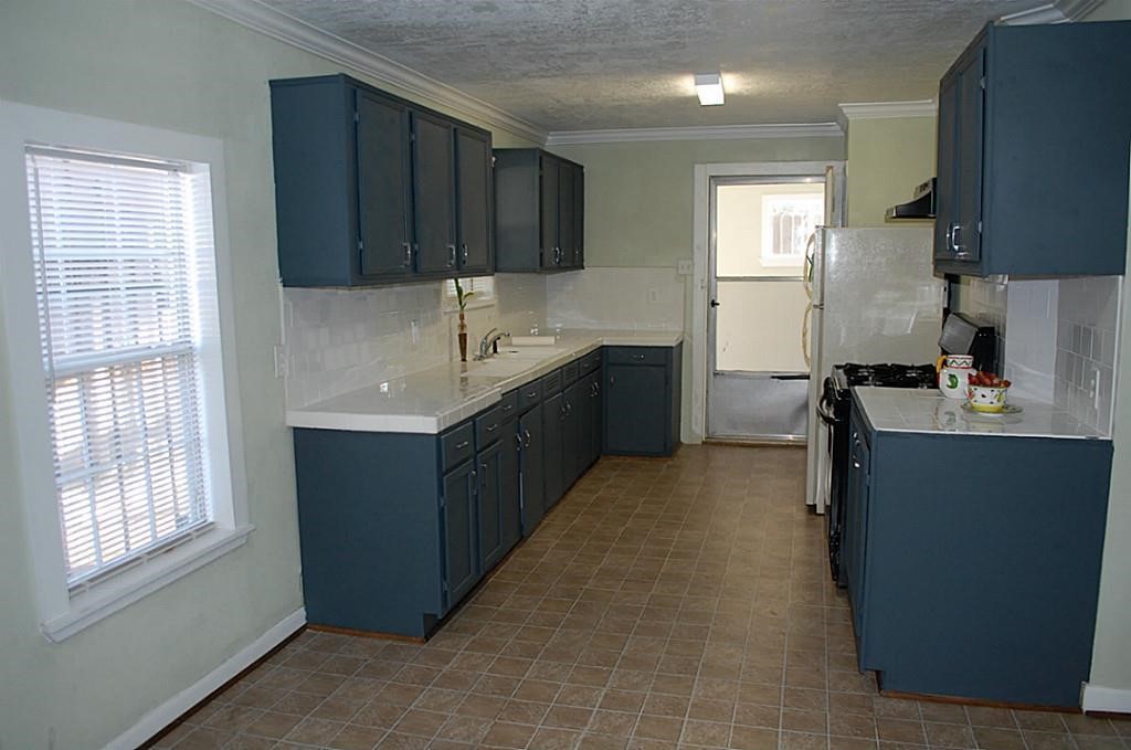 3804 Garrow Street Houston, TX 77003 - Photo 12 of 22 a kitchen with granite countertop a sink stove and cabinets
