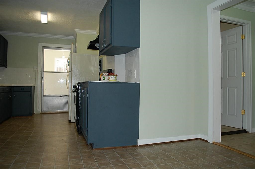 3804 Garrow Street Houston, TX 77003 - Photo 13 of 22 a kitchen with a refrigerator and a stove top oven
