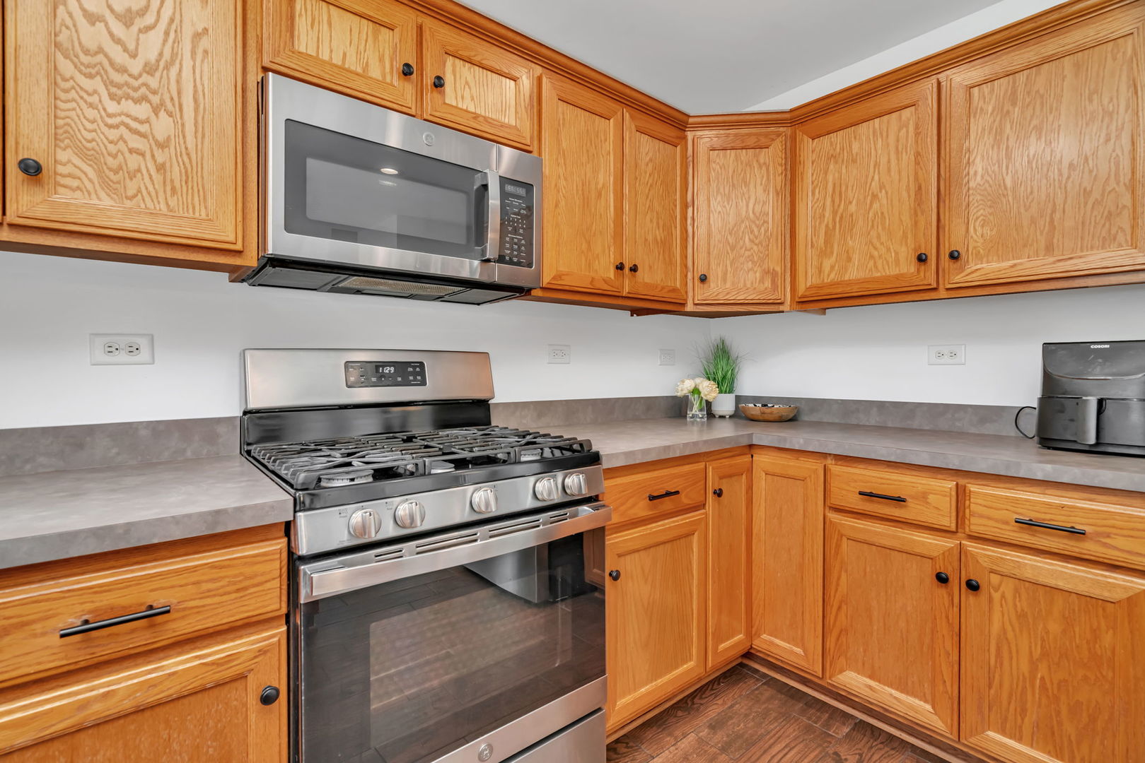 1110 Sandstone Drive Diamond, IL 60416 - Photo 20 of 49 a kitchen with stainless steel appliances granite countertop white cabinets and a stove top oven