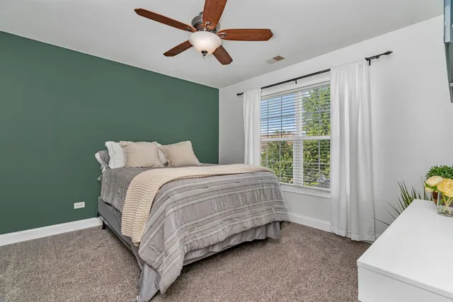 a bedroom with a bed and window