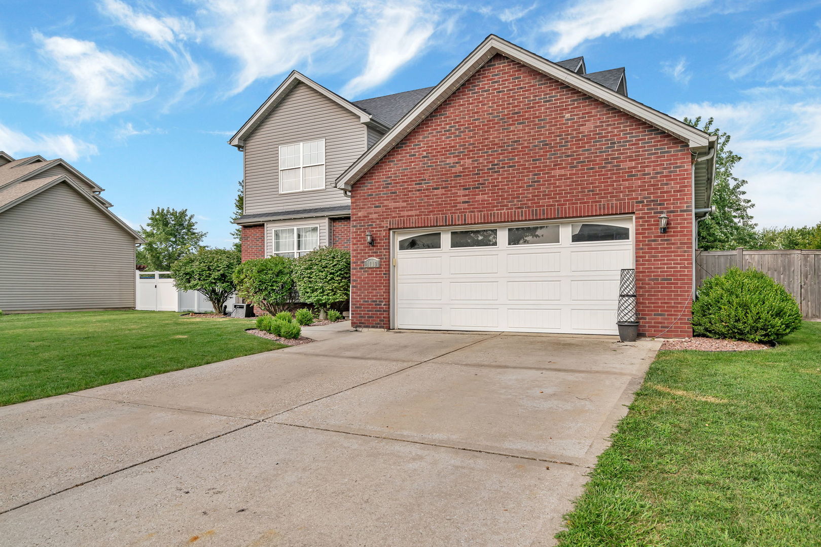 1110 Sandstone Drive Diamond, IL 60416 - Photo 47 of 49 a front view of a house with a yard and garage