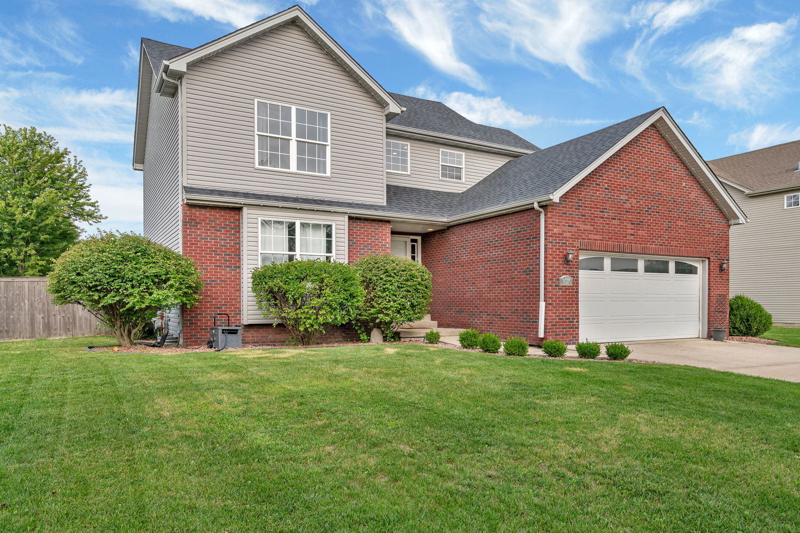 1110 Sandstone Drive Diamond, IL 60416 - Photo 49 of 49 a front view of a house with a yard and garage