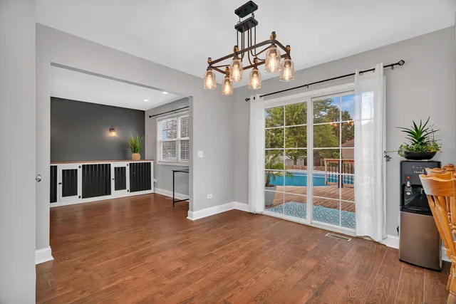 a view of a dining room with furniture window and wooden floor