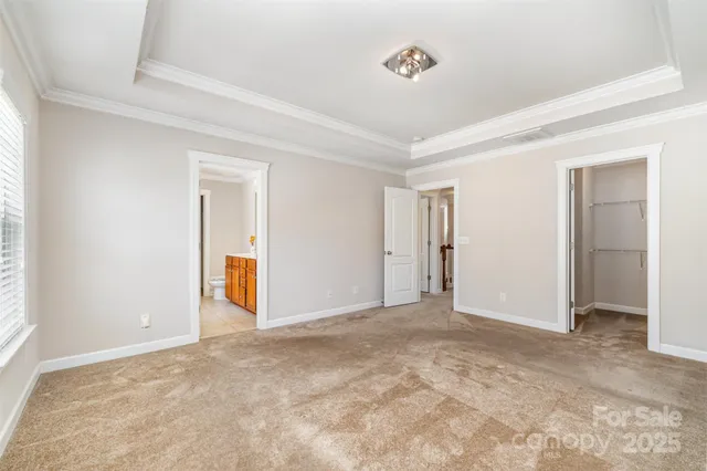 a bathroom with a granite countertop sink a toilet a mirror and shower
