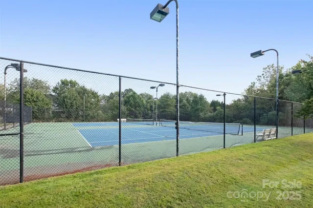 a view of a porch with wooden floor and fence next to a yard