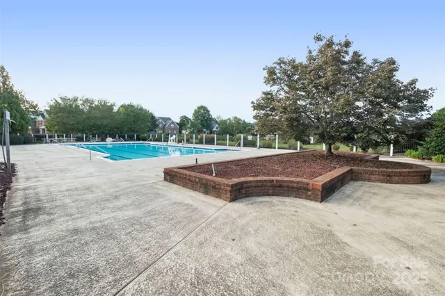 a view of a house with swimming pool and a yard