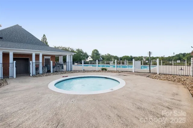 an empty room with windows and fireplace