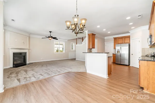 a view of a kitchen with a sink oven refrigerator and wooden floor