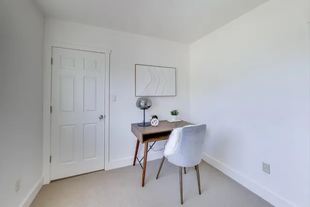 a view of a workspace with furniture and wooden floor