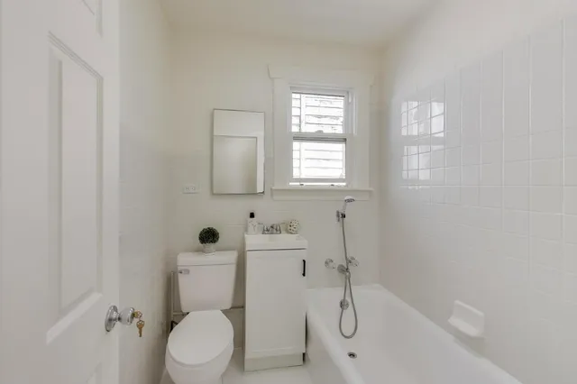 a bathroom with a toilet sink and shower