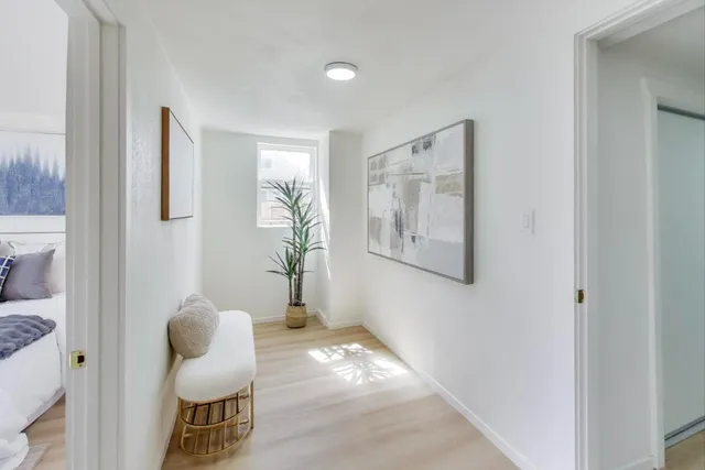 a view of room with furniture and wooden floor