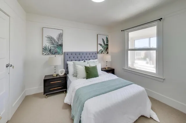 a bedroom with bed and a window