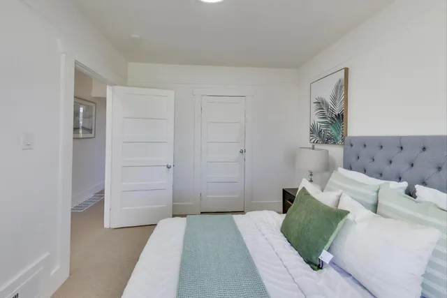 a bedroom with a bed and a couch