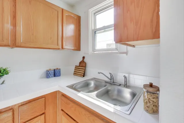 a kitchen with a sink cabinets and a window