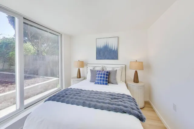 a bedroom with a large bed and a window