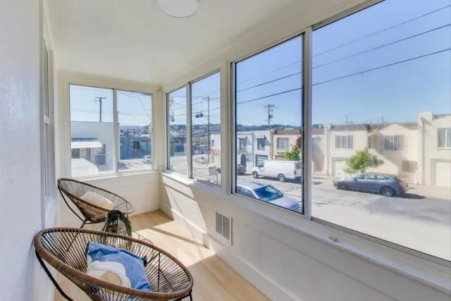 a living room with furniture and a floor to ceiling window
