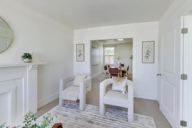 a view of a room that has a bed and a mirror in it