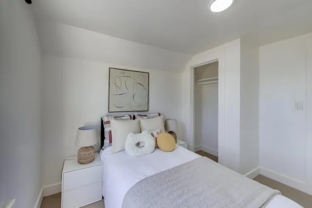 a bedroom with a bed and hallway