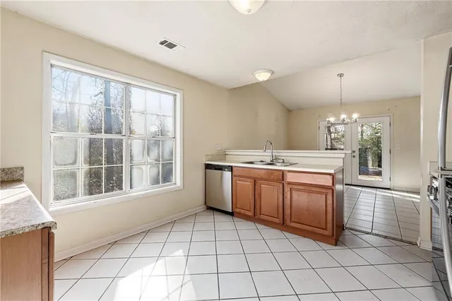a kitchen with a stove a sink and a refrigerator