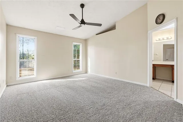 a view of a livingroom with a ceiling fan and window