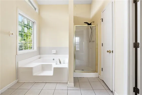 a bathroom with a bathtub sink and shower