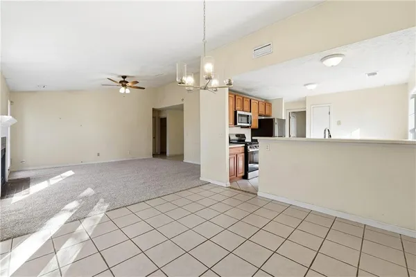 a view of a kitchen and a livingroom with furniture
