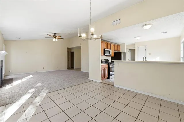 a view of a kitchen and a livingroom with furniture
