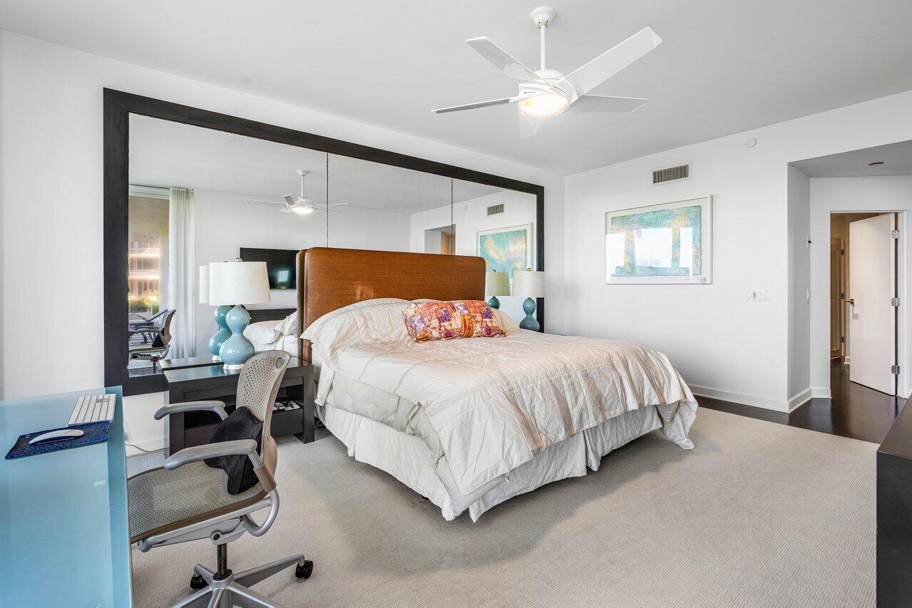 3001 Southeast Island Point Lane, Unit 12 Stuart, FL 34996 - Photo 17 of 44 a bedroom with a bed and a chandelier