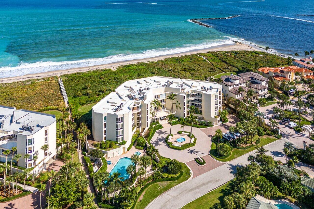 3001 Southeast Island Point Lane, Unit 12 Stuart, FL 34996 - Photo 37 of 44 a view of a swimming pool with lawn chairs and potted plants