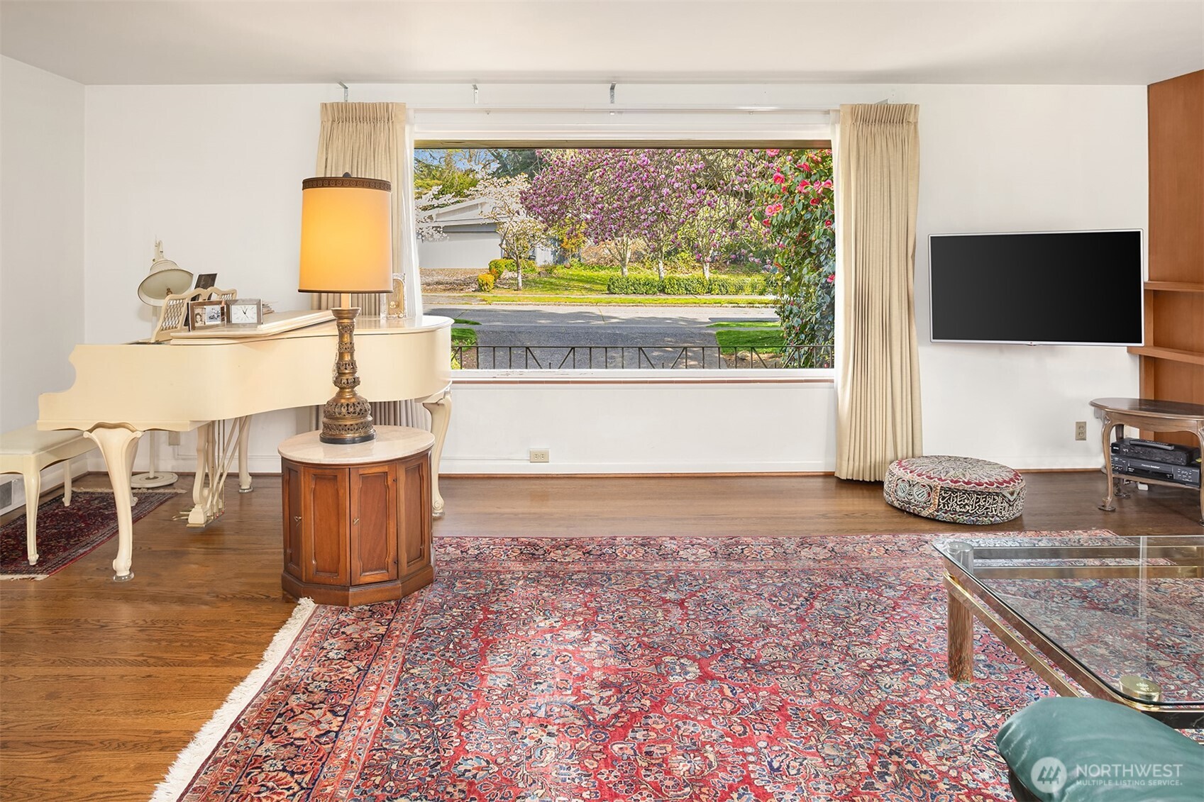 5429 Northeast Windermere Road Seattle, WA 98105 - Photo 6 of 21 a living room with a table and a flat screen tv