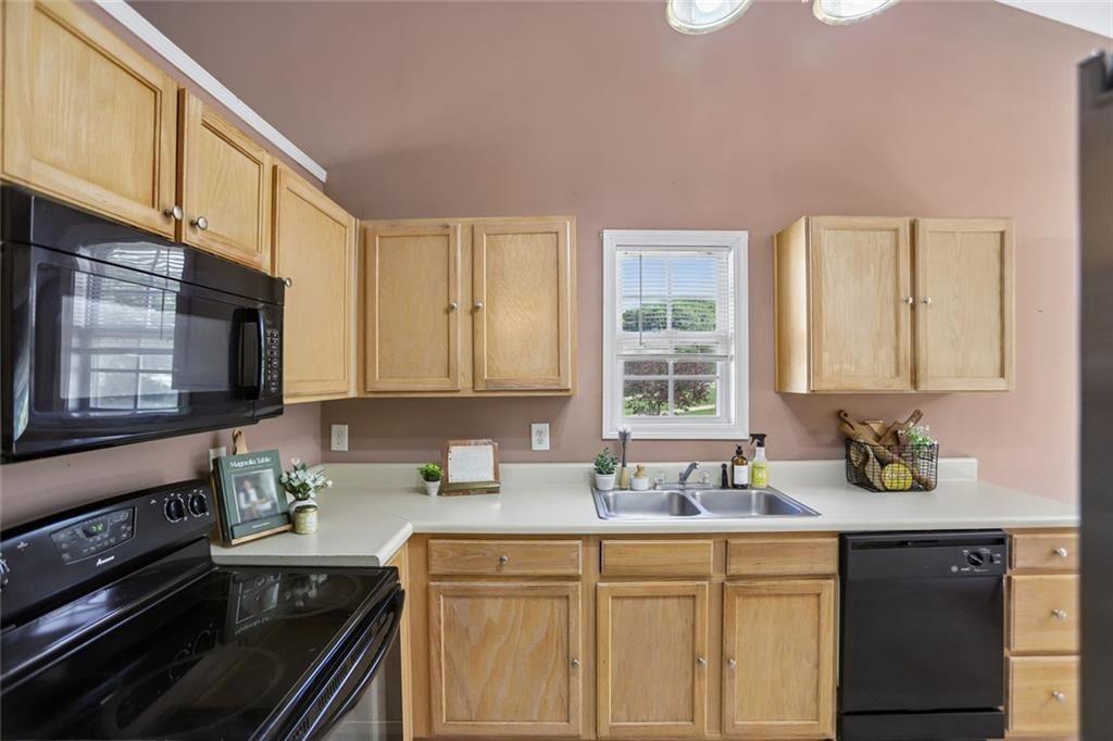9720 Poole Road Villa Rica, GA 30180 - Photo 13 of 40 a kitchen with sink a stove and cabinets