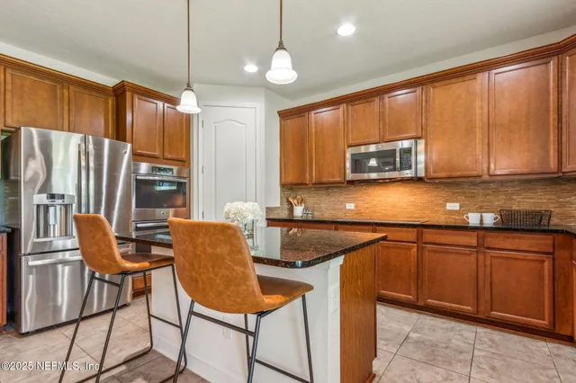 a kitchen with granite countertop white cabinets and sink