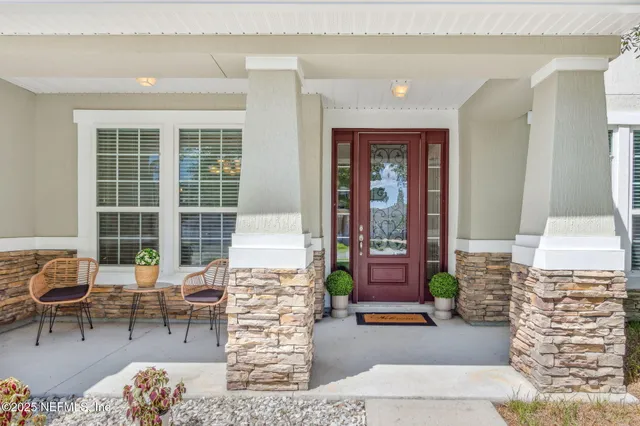 a building outdoor space with patio furniture and potted plants