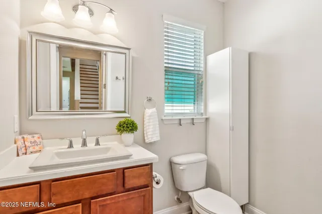 a spacious bedroom with a bed and a chandelier