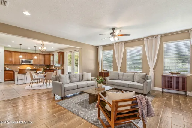 a living room with furniture and a view of kitchen