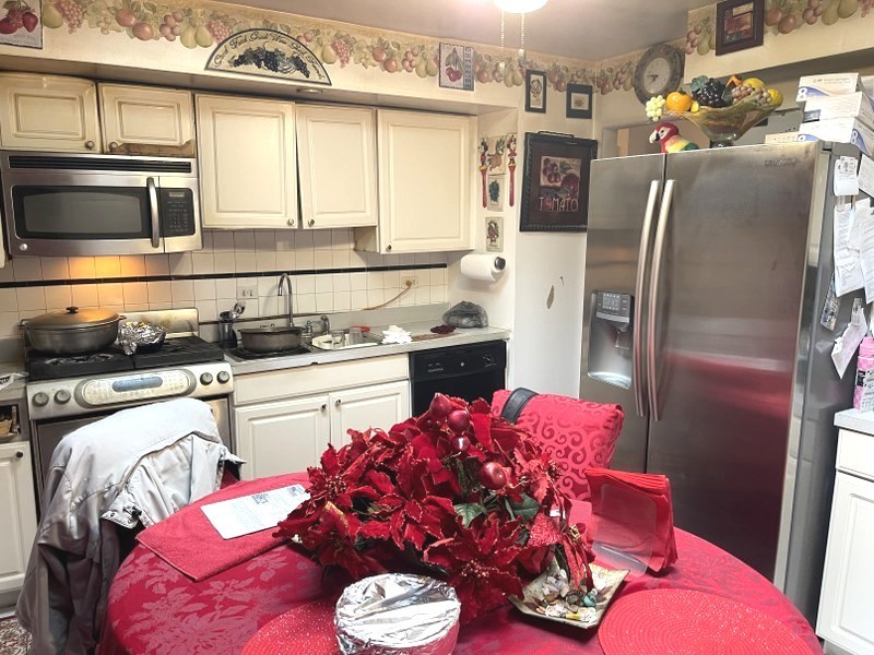 598 Miner Drive Bolingbrook, IL 60440 - Photo 6 of 13 a kitchen with stainless steel appliances granite countertop a sink stove and refrigerator