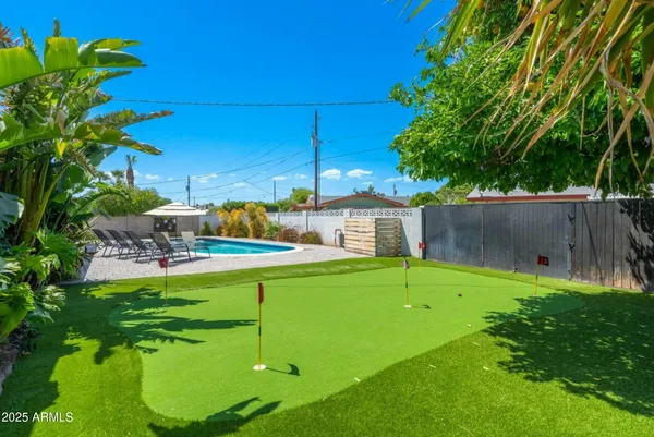a view of a house with a backyard