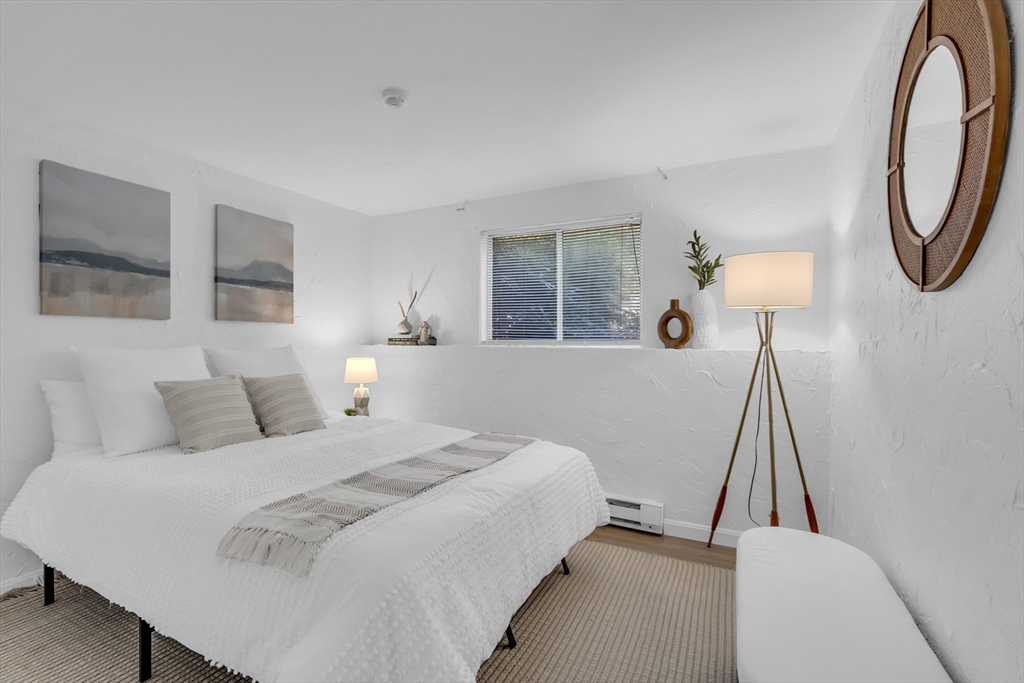 208 Swanson Road, Unit 526 Boxborough, MA 01719 - Photo 13 of 23 a bedroom with a bed and a lamp
