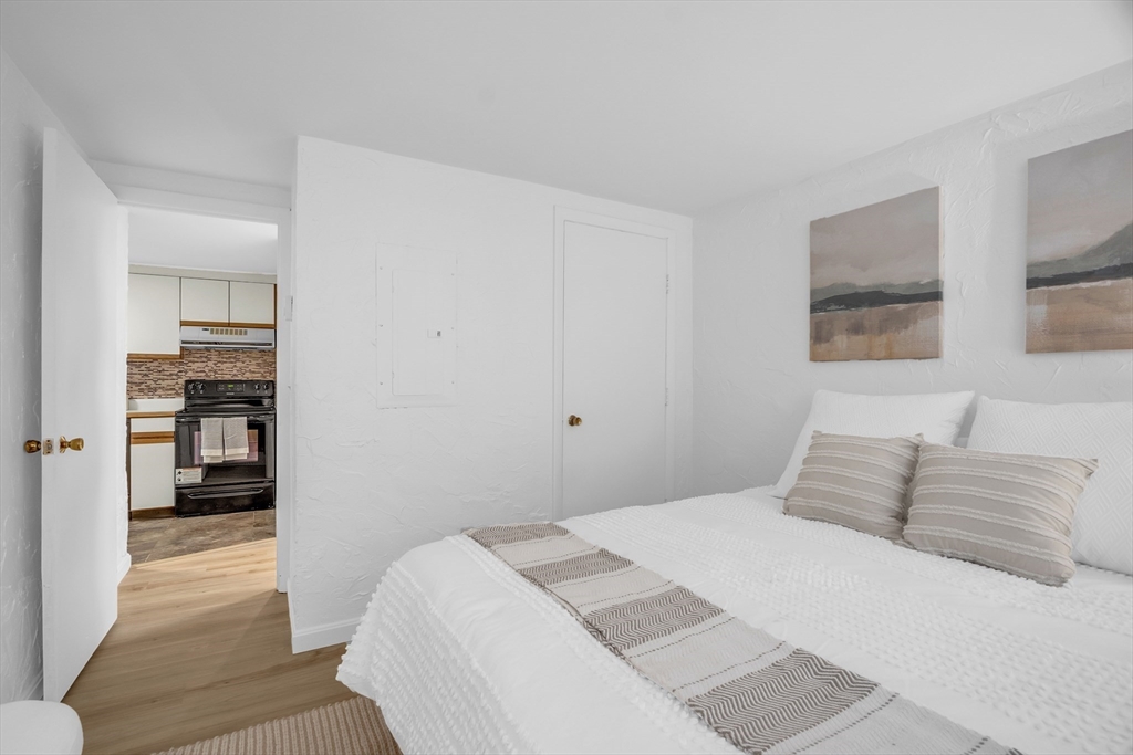 208 Swanson Road, Unit 526 Boxborough, MA 01719 - Photo 16 of 23 a bedroom with a bed and a view of bathroom