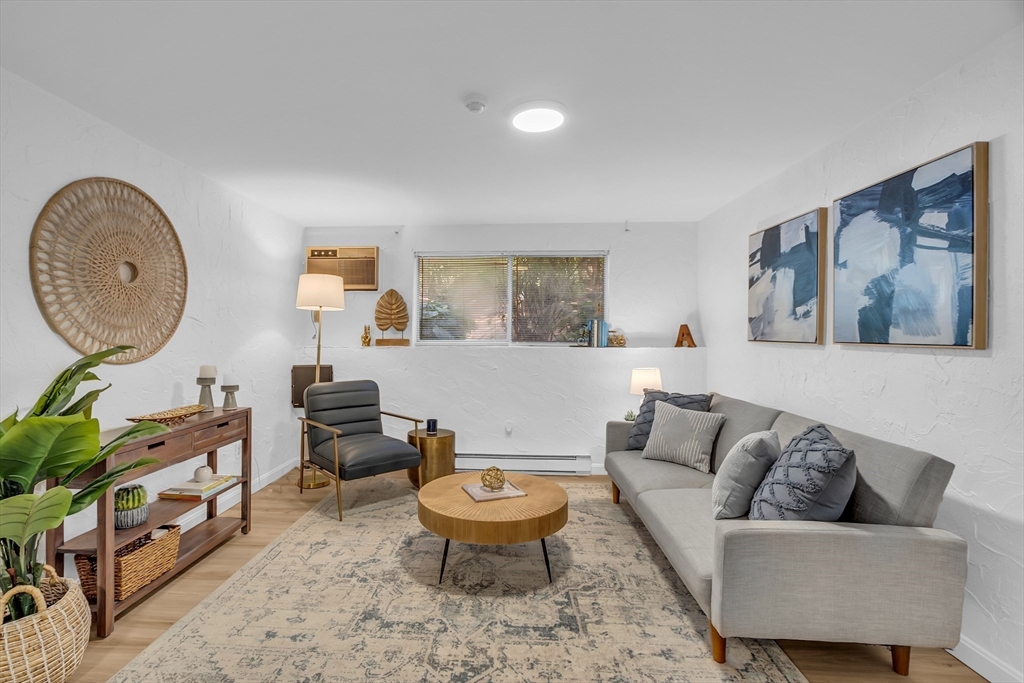 208 Swanson Road, Unit 526 Boxborough, MA 01719 - Photo 2 of 23 a living room with furniture and a large window