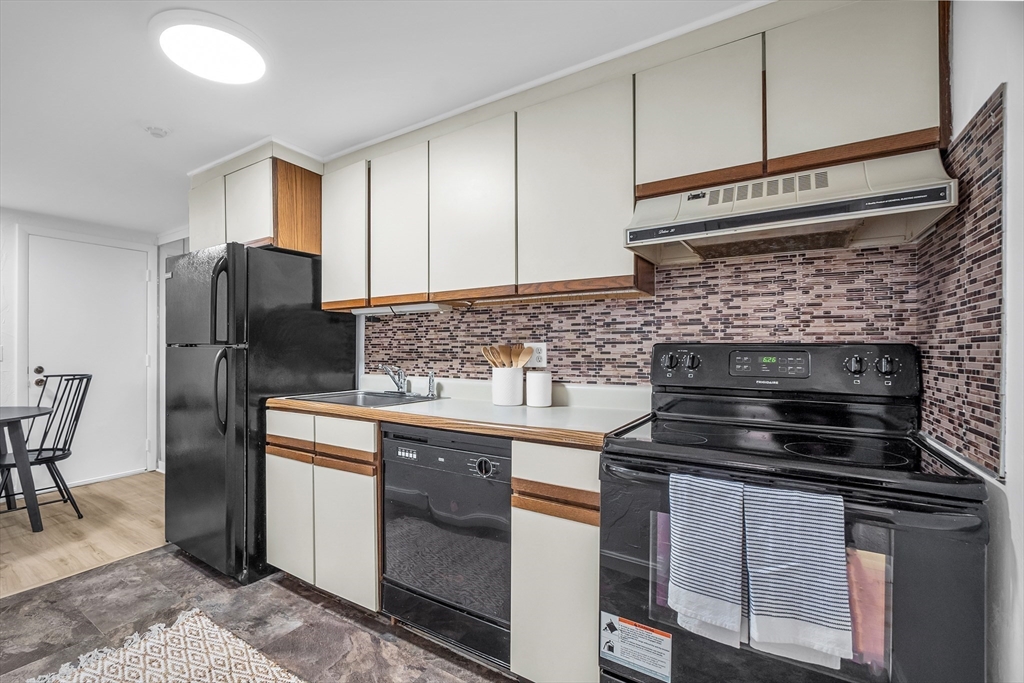 208 Swanson Road, Unit 526 Boxborough, MA 01719 - Photo 9 of 23 a kitchen with appliances cabinets and a counter top space